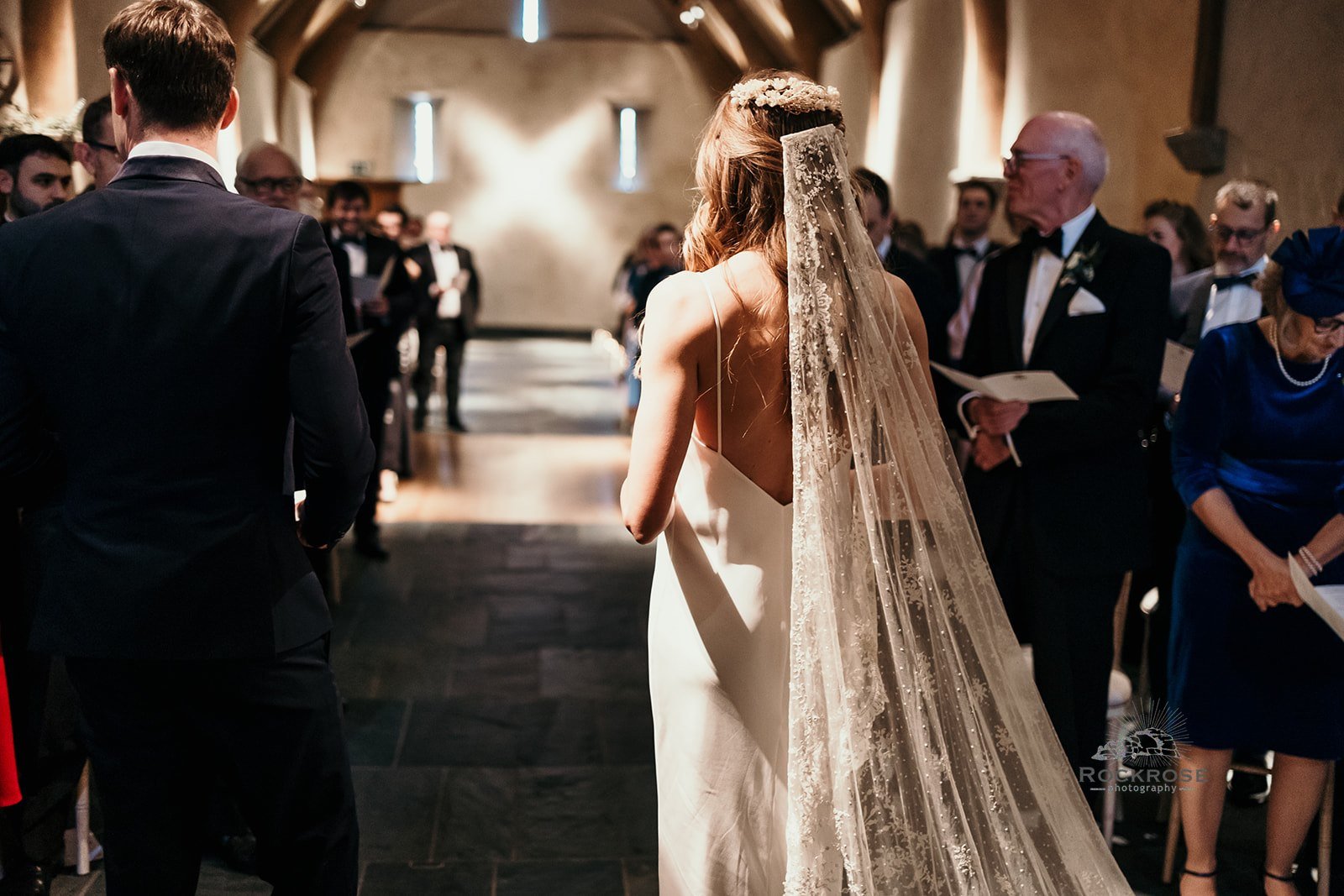 A photo of bride and groom at the top of the aisle in wedding venue
