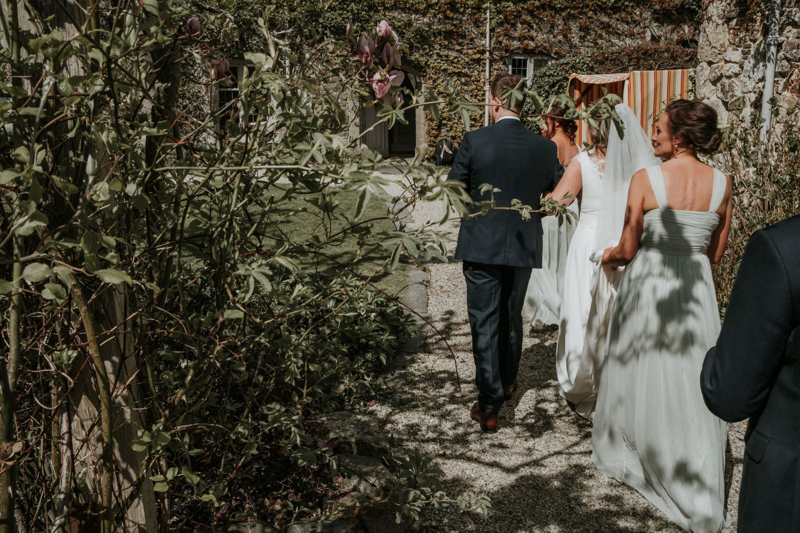 Z&D_wedding.1288 copy wedding day couple bride and groom walk through gardens of the great barn devon wedding venue