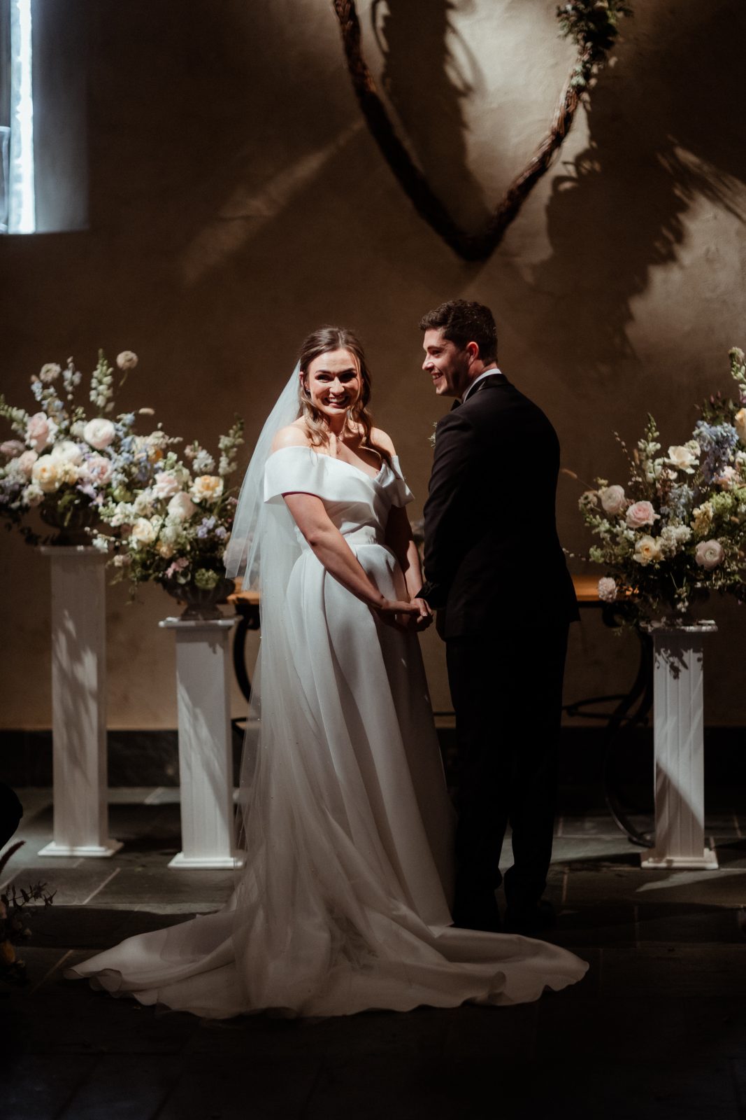 Bride and groom during their civil ceremony inside the historic barn at The Great Barn Devon