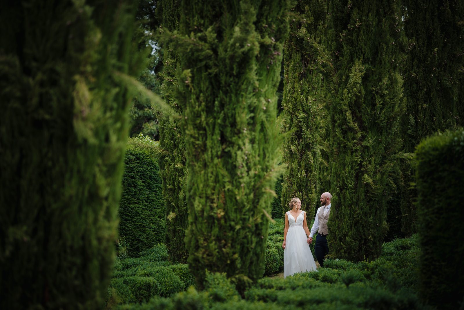 bride and groom marry at the great barn devon wedding venue in the gardens
