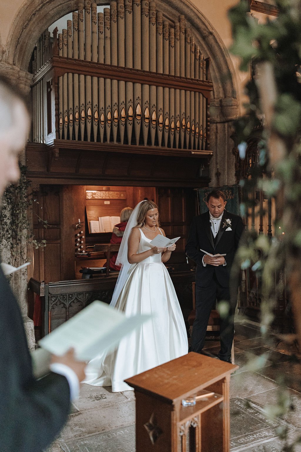 Bride and groom during their traditional church ceremony as part of their wedding weekend at The Great Barn Devon