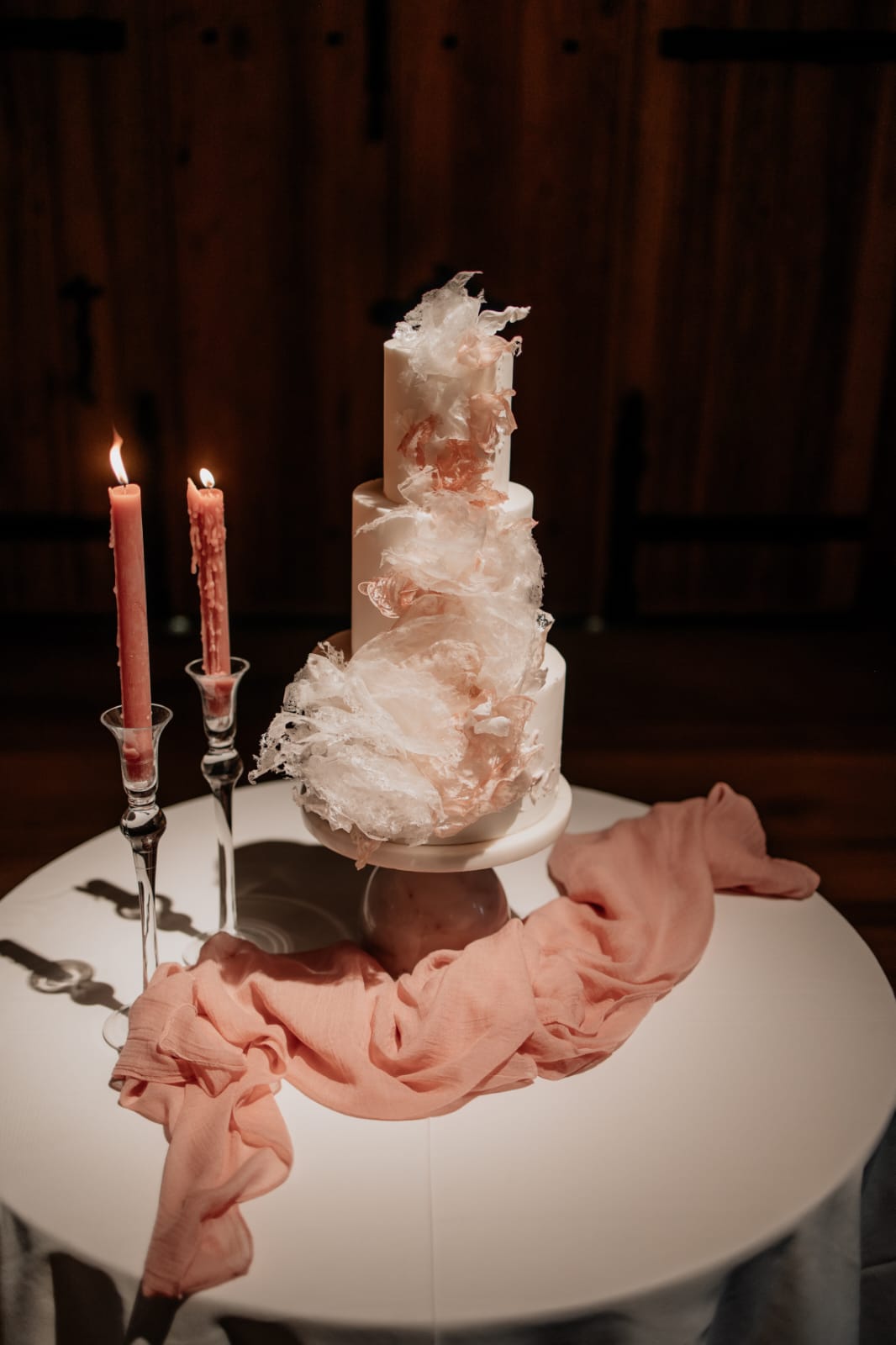 Wedding cake table on display inside The Great Barn Devon, luxury 15th century wedding venue in the countryside near Exeter Devon UK