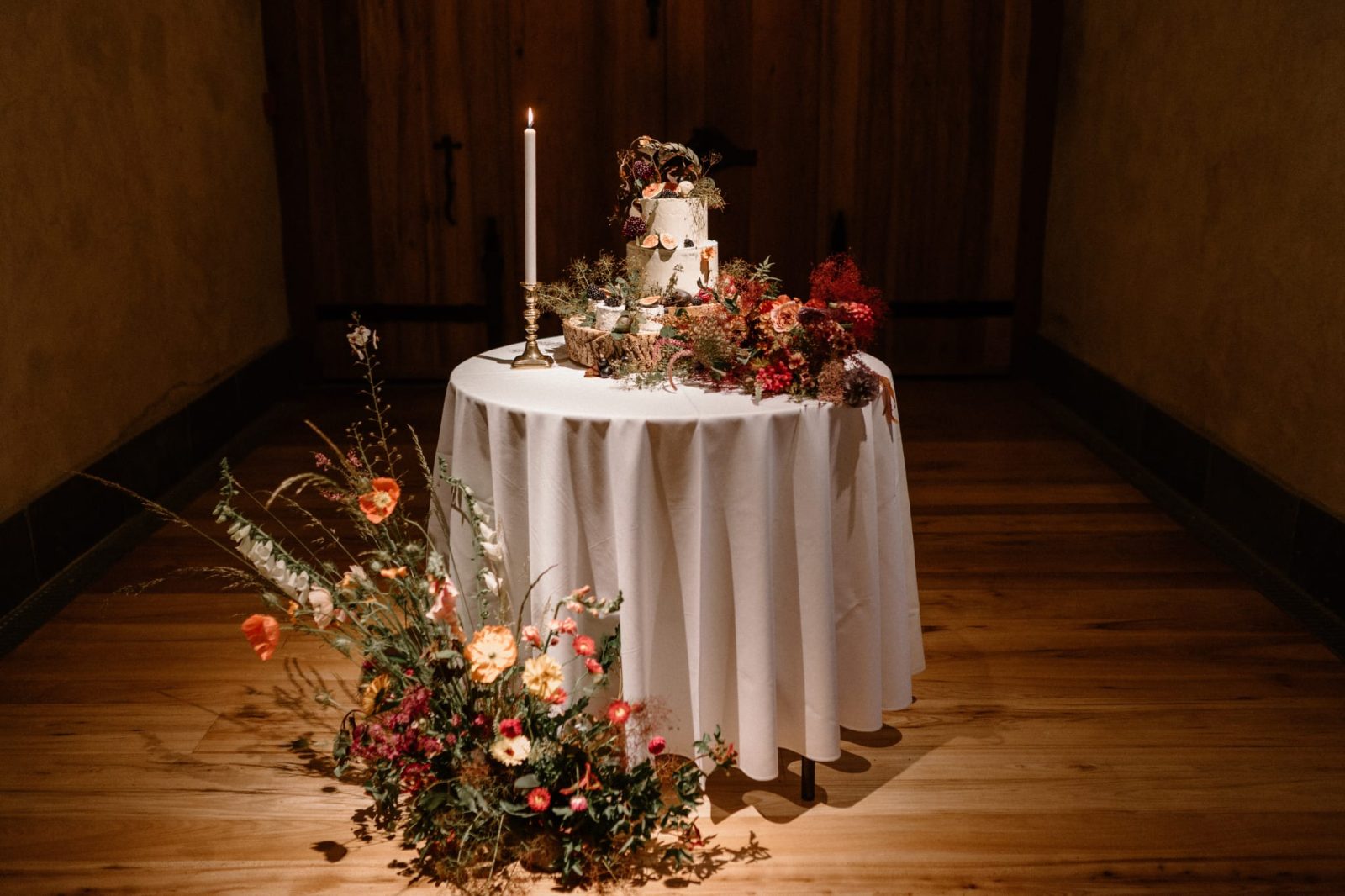Wedding cake table on display inside The Great Barn Devon, luxury 15th century wedding venue in the countryside near Exeter Devon UK
