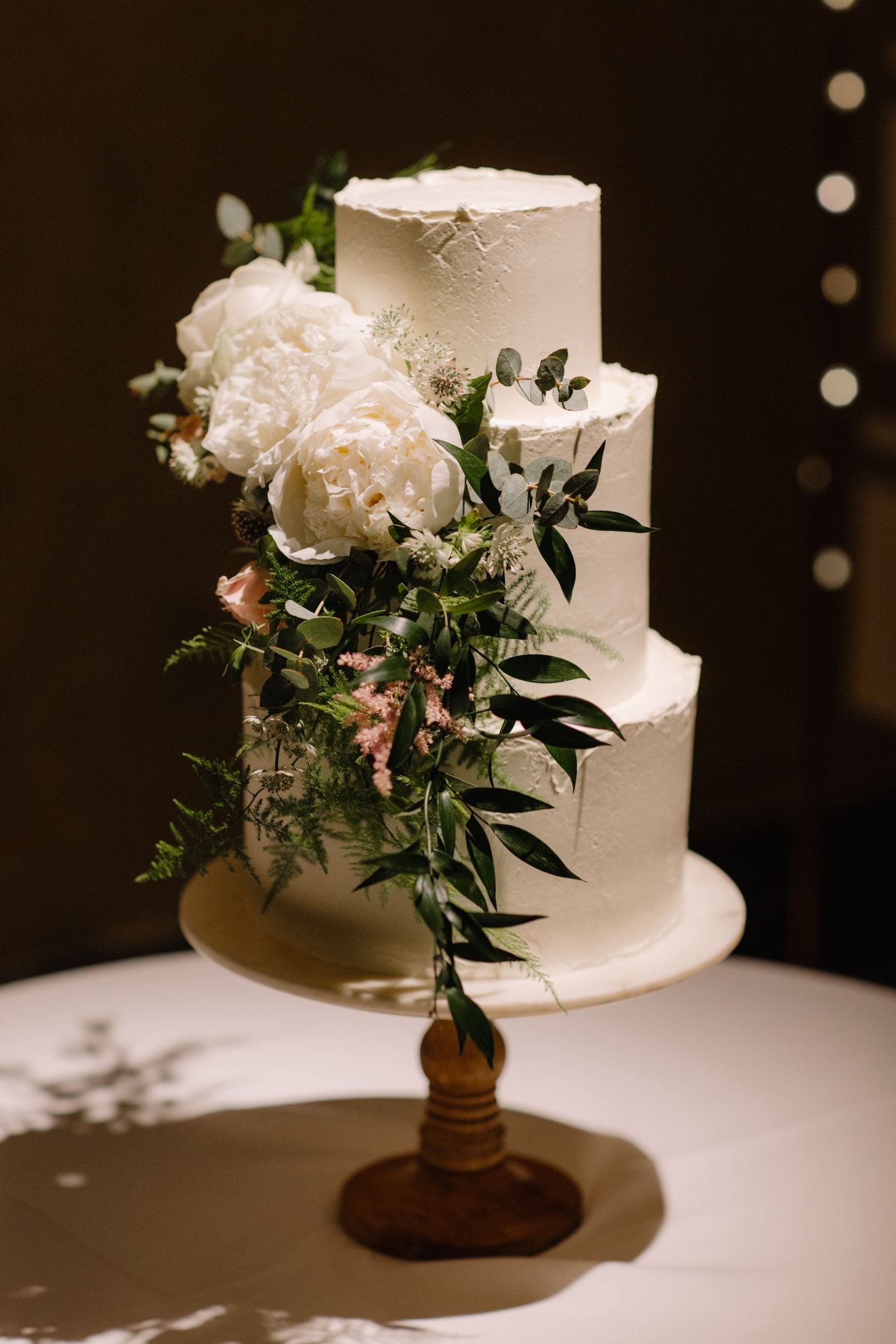 Wedding cake table on display inside The Great Barn Devon, luxury 15th century wedding venue in the countryside near Exeter Devon UK