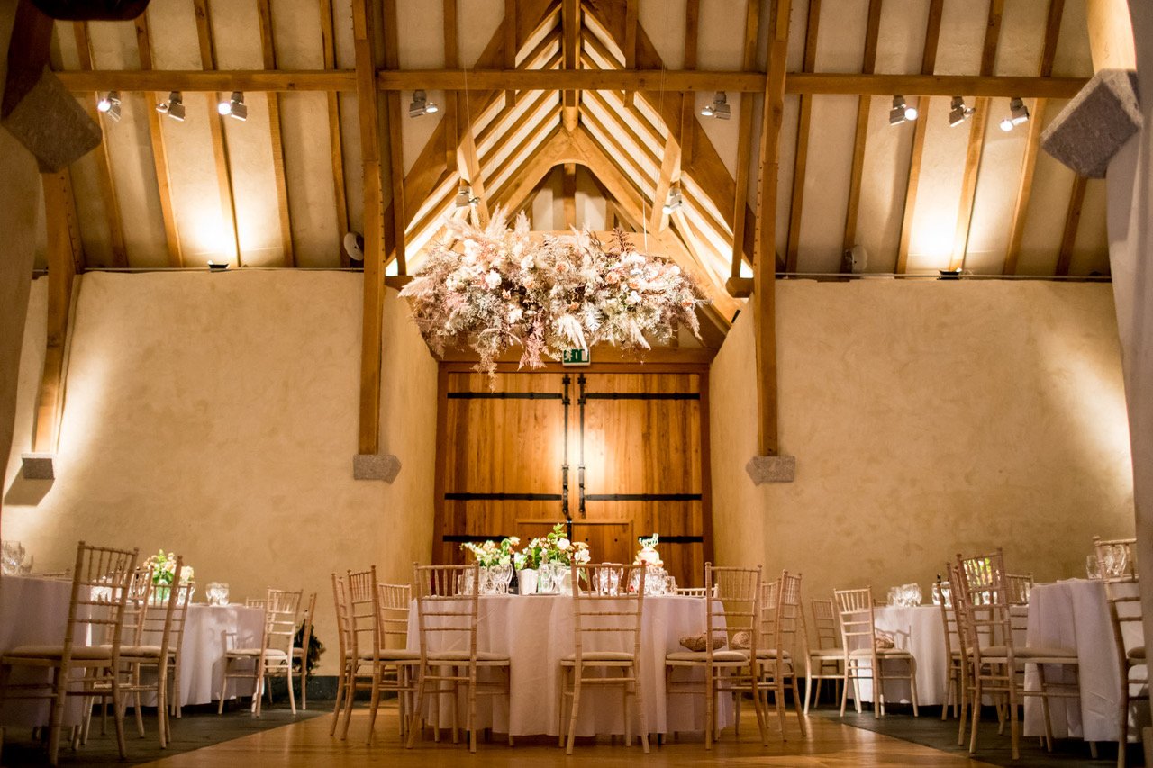 wedding flowers by Emma Hewlett Floral design, displayed in the interior of 15th century great barn | The Great Barn Devon supplier spotlight