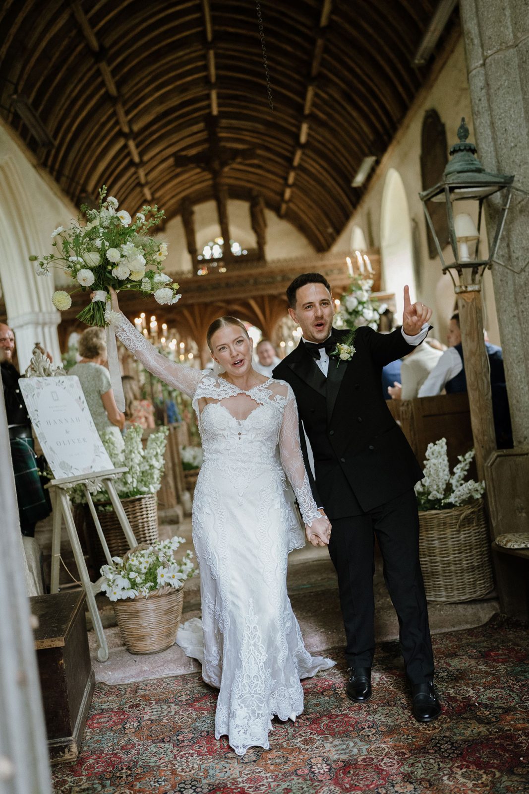 Hannah and Oli celebrating their wedding at The Great Barn Devon, featured in Wed Magazine