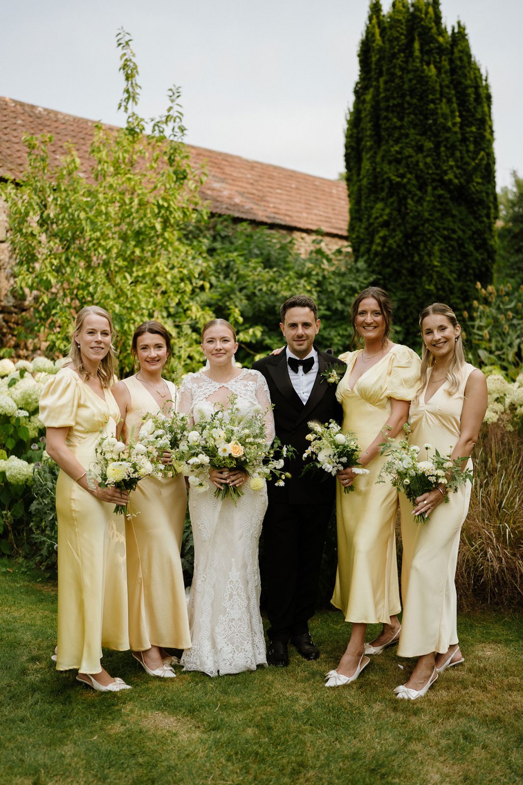 Hannah and Oli celebrating their wedding at The Great Barn Devon, featured in Wed Magazine