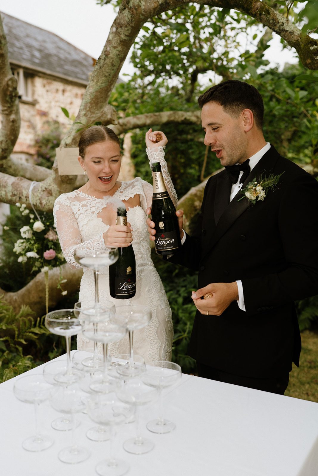 Hannah and Oli celebrating their wedding at The Great Barn Devon, featured in Wed Magazine