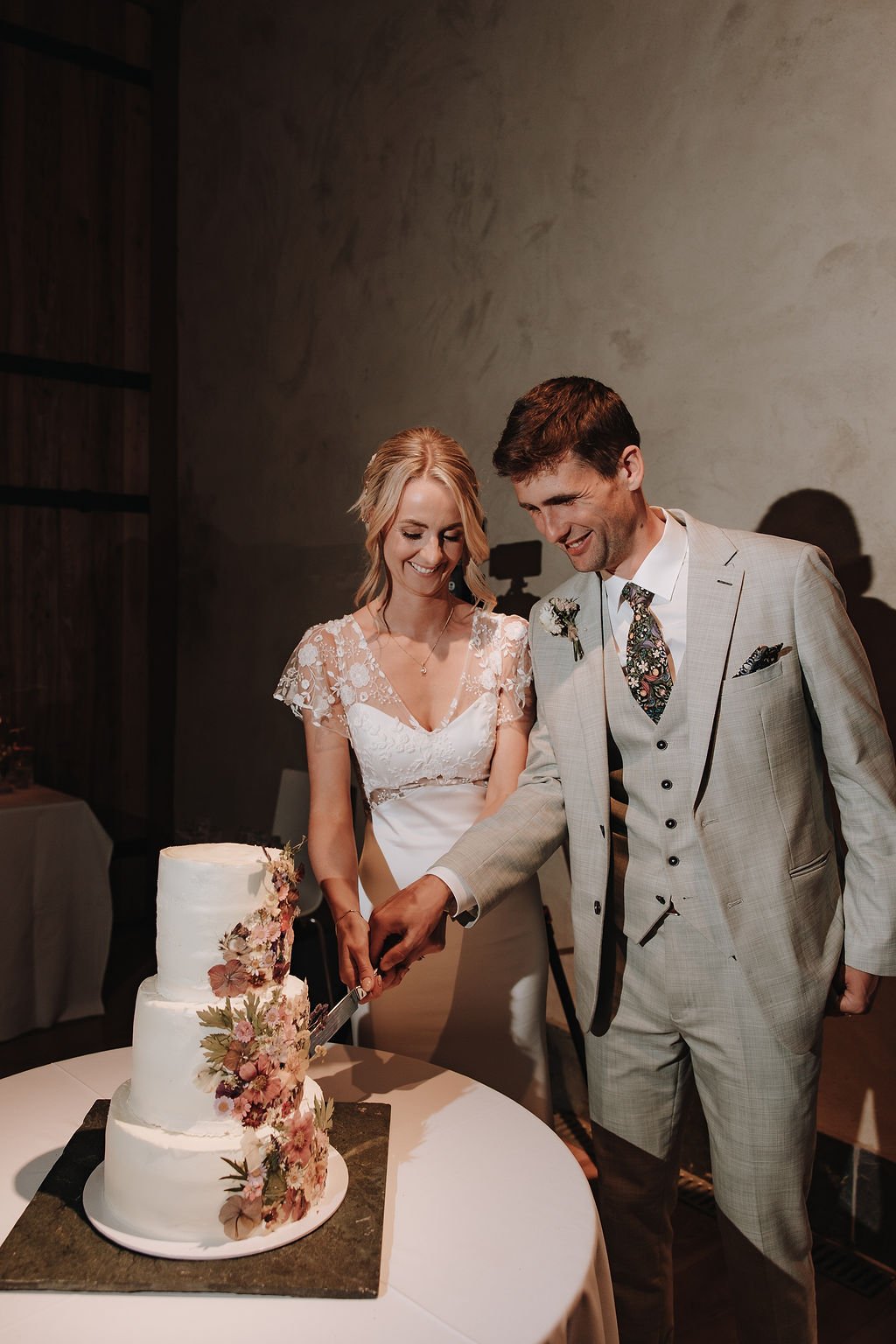 bride and groom cutting their 3 tier wedding cake together