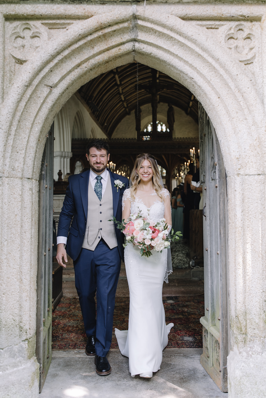bride and groom at the door of the church Higher Ashton devon